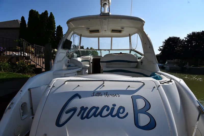 Slide: The Image of 2006 Formula 40 Performance Cruiser named "Gracie B" docked by a waterfront home. - 11