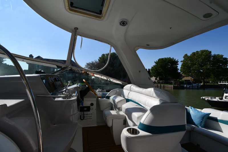 Slide: The Image of Interior of a 2006 Formula 40 Performance Cruiser with white seating and a scenic water view. - 19