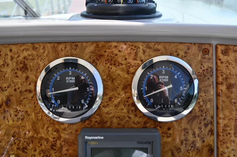 Slide: The Image of Dashboard of 2006 Formula 40 Performance Cruiser with RPM gauges and Raymarine display. - 16