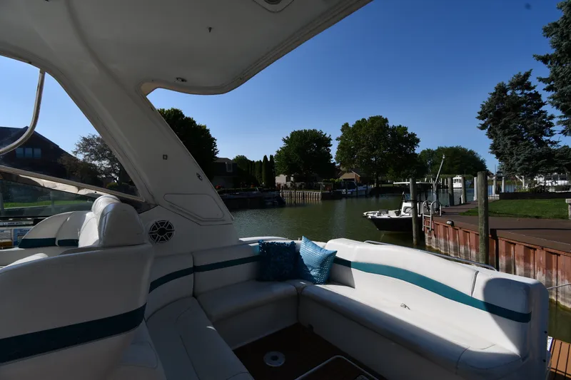 Slide: The Image of 2006 Formula 40 Performance Cruiser interior with waterfront view, featuring white seating and blue accents. - 23
