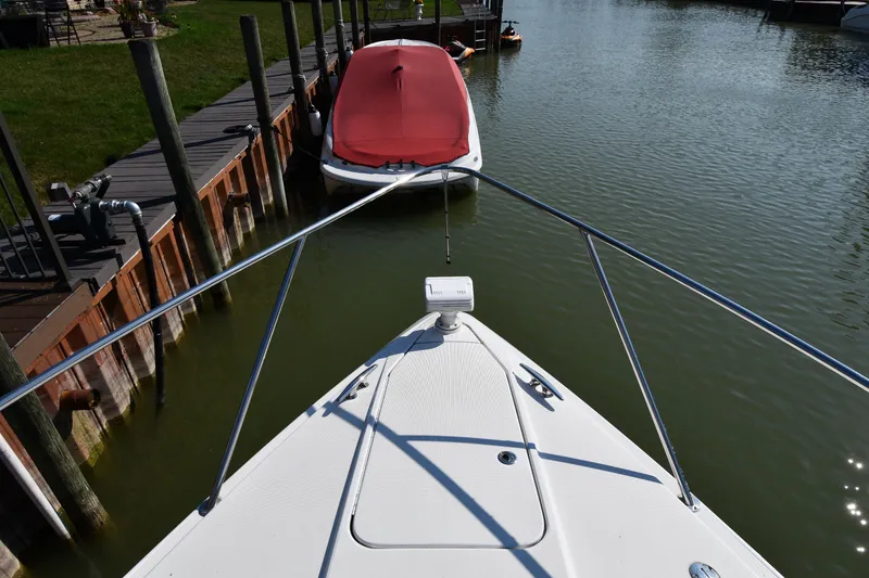Slide: The Image of 2006 Formula 40 Performance Cruiser docked, view from bow, calm water, sunny day. - 8