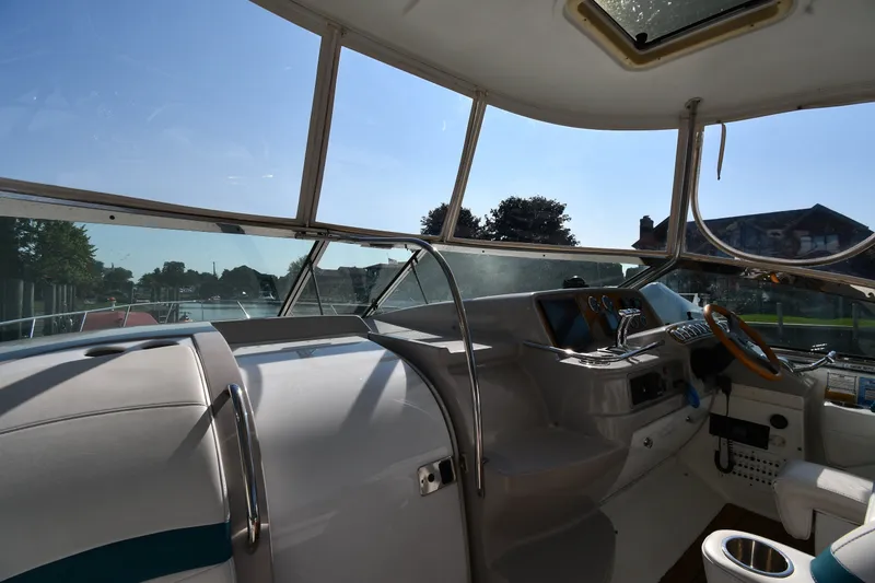 Slide: The Image of Interior view of a 2006 Formula 40 Performance Cruiser cockpit with steering wheel and controls. - 12