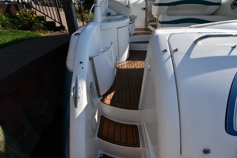 Slide: The Image of 2006 Formula 40 Performance Cruiser with teak deck, docked beside a wooden pier. - 25