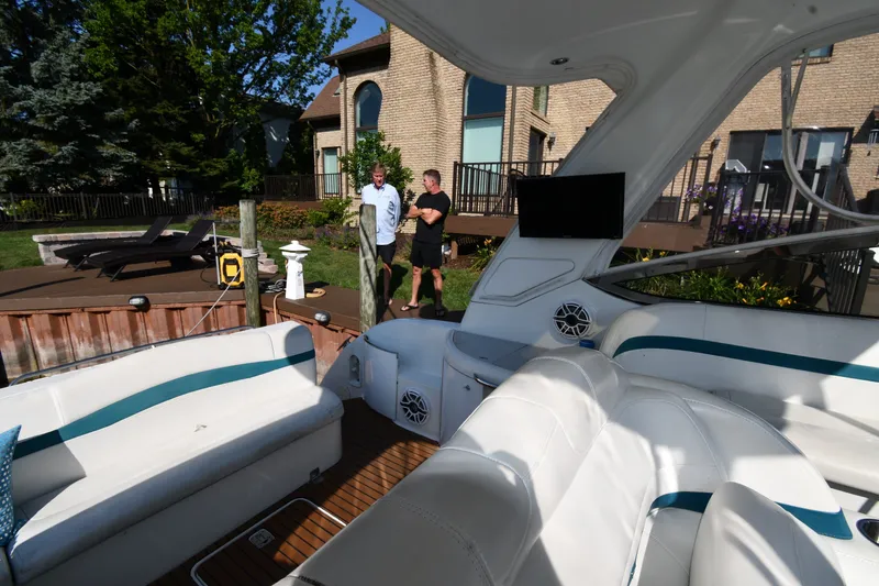 Slide: The Image of 2006 Formula 40 Performance Cruiser docked near a house with two people conversing. - 22