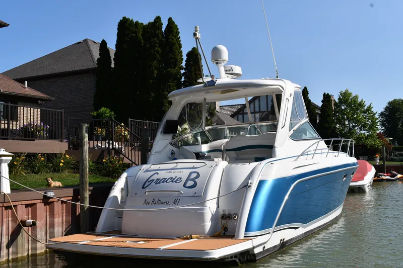 Slide: The Image of 2006 Formula 40 Performance Cruiser docked by a waterfront home. - 2