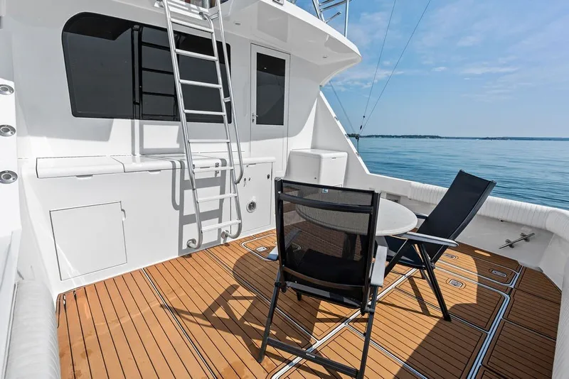 Slide: The Image of Spacious deck of 1999 Hatteras 60 Convertible yacht with seating and ocean view. - 18