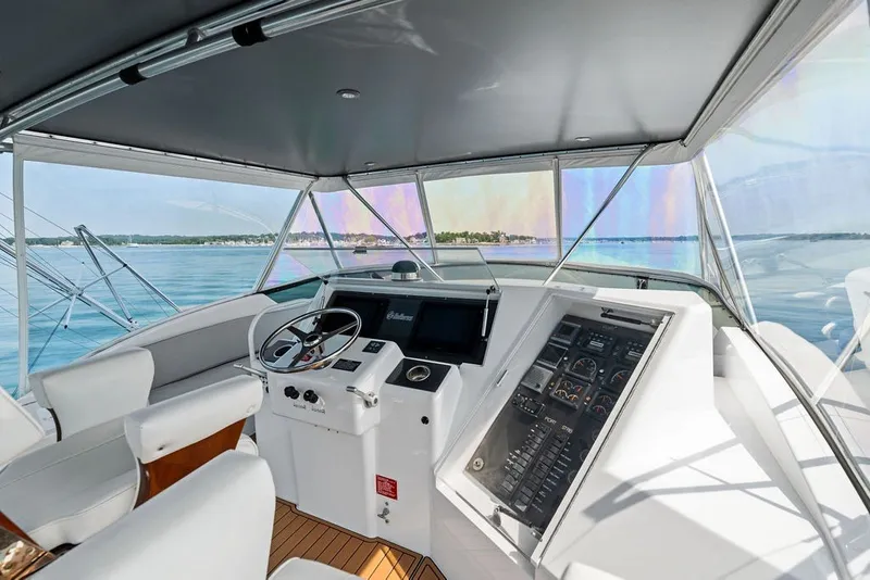 Slide: The Image of Interior view of 1999 Hatteras 60 Convertible yacht cockpit with steering and control panels. - 26