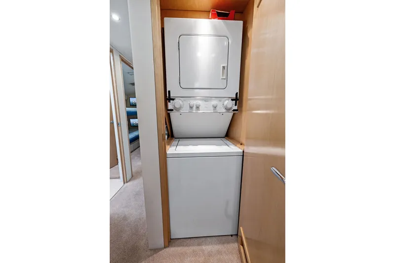 Slide: The Image of Stacked washer and dryer in 1999 Hatteras 60 Convertible yacht interior. - 52