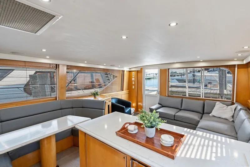 Slide: The Image of Luxurious interior of 1999 Hatteras 60 Convertible yacht with modern seating and decor. - 38