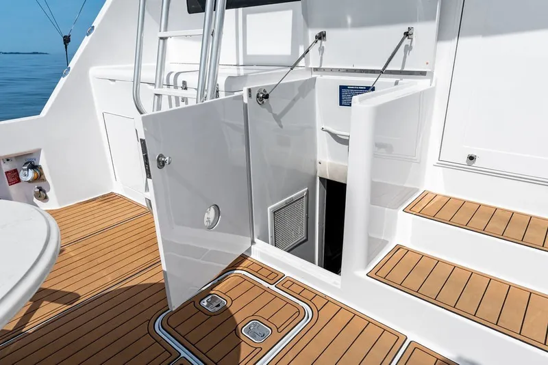 Slide: The Image of 1999 Hatteras 60 Convertible yacht deck with open hatch and ladder. - 22