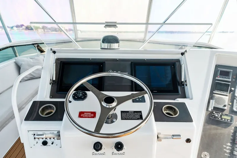 Slide: The Image of Helm of 1999 Hatteras 60 Convertible yacht with modern navigation equipment. - 27