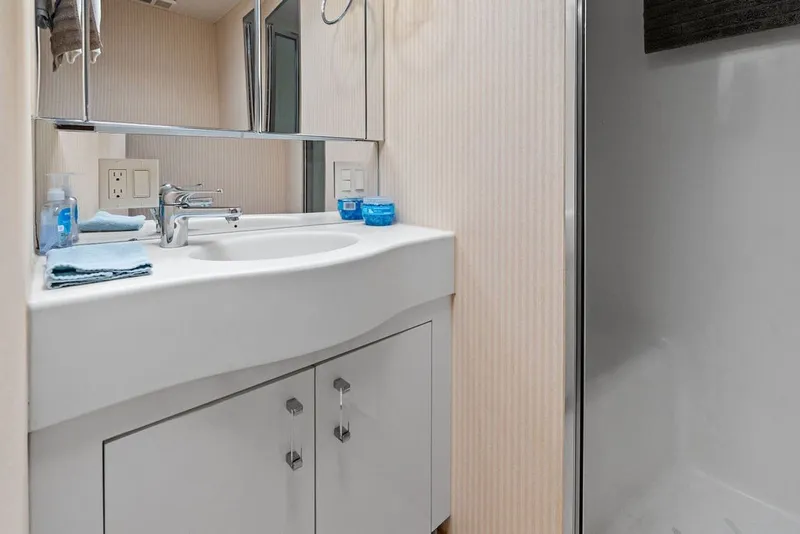 Slide: The Image of Bathroom interior of 1999 Hatteras 60 Convertible yacht with modern sink and mirror. - 50