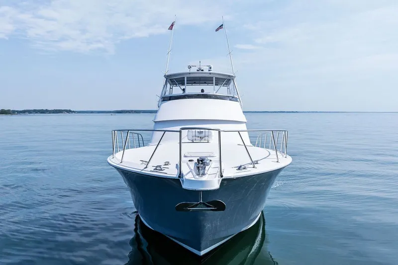 Slide: The Image of 1999 Hatteras 60 Convertible yacht on calm water, front view. - 3
