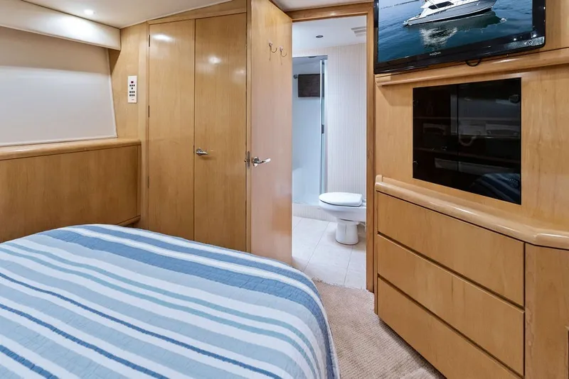 Slide: The Image of Luxurious cabin interior of 1999 Hatteras 60 Convertible yacht with ensuite bathroom. - 49