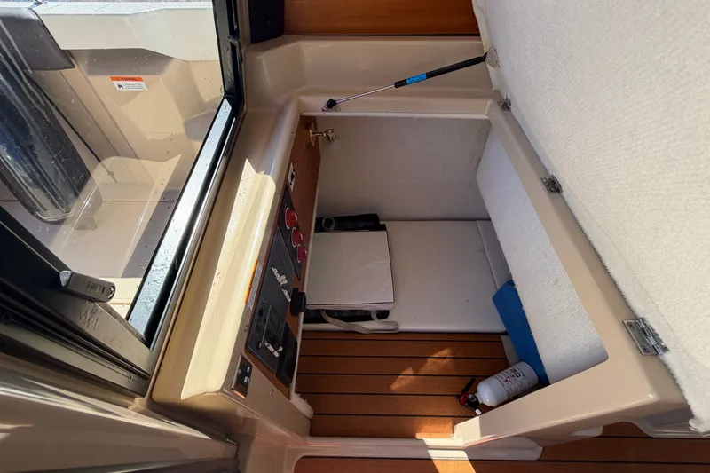 Slide: The Image of Interior view of a 2017 Ranger Tugs R-23 boat cabin with storage and fire extinguisher. - 14