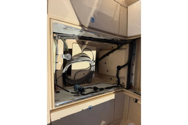 Slide: The Image of 2017 Ranger Tugs R-23 boat interior wiring and storage compartment. - 23