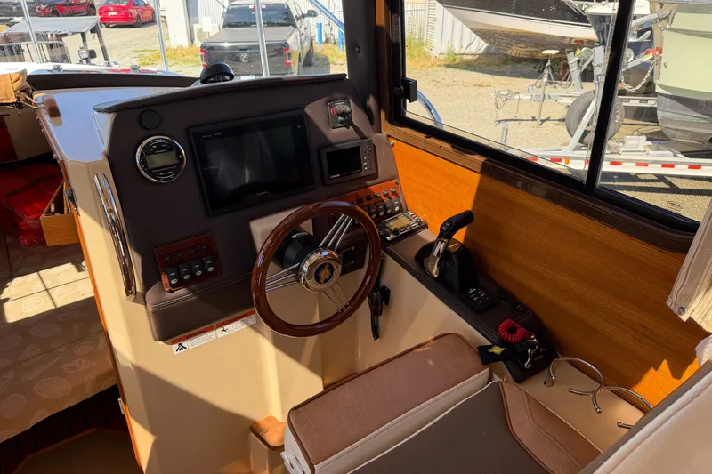 Slide: The Image of Interior helm of 2017 Ranger Tugs R-23 boat with steering wheel and control panel. - 15