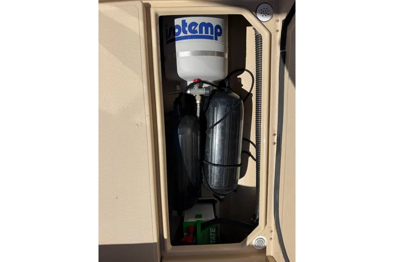 Slide: The Image of 2017 Ranger Tugs R-23 boat compartment with water heater and storage tanks. - 22