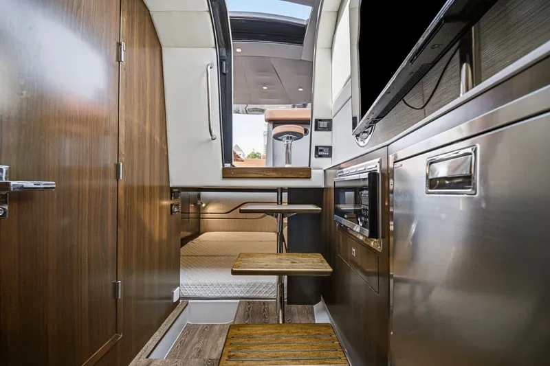Slide: The Image of Luxurious interior of 2022 Cruisers Yachts 42 GLS I/O with modern amenities and wooden accents. - 35
