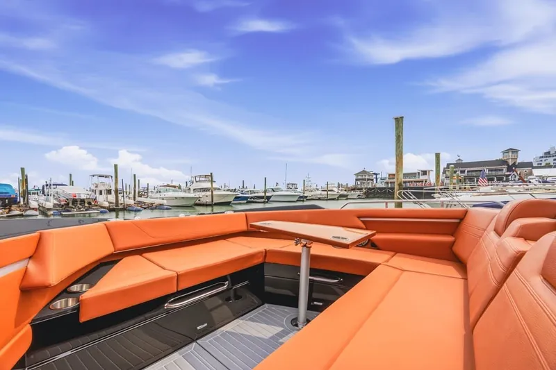 Slide: The Image of Luxurious 2022 Cruisers Yachts 42 GLS I/O with orange seating at a marina. - 37