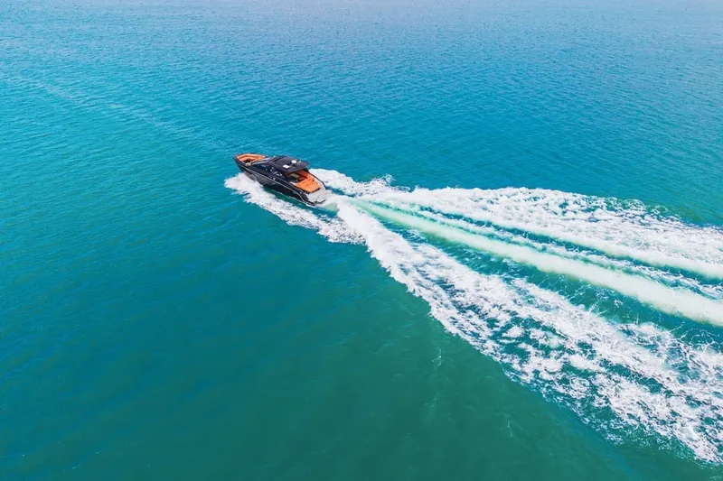 Slide: The Image of 2022 Cruisers Yachts 42 GLS I/O cruising on clear blue ocean waters. - 16
