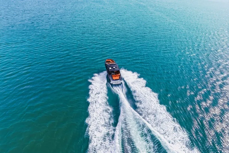 Slide: The Image of Aerial view of 2022 Cruisers Yachts 42 GLS I/O cruising on blue ocean waters. - 15