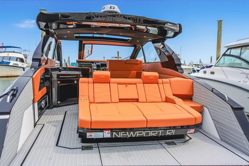 Slide: The Image of 2022 Cruisers Yachts 42 GLS I/O with orange seating, docked in Newport, RI marina. - 56