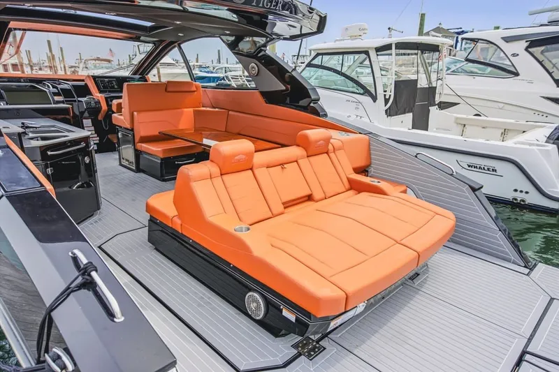 Slide: The Image of Luxurious 2022 Cruisers Yachts 42 GLS I/O with vibrant orange seating and sleek design. - 57