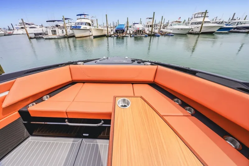 Slide: The Image of 2022 Cruisers Yachts 42 GLS I/O with orange seating, docked in a marina. - 38