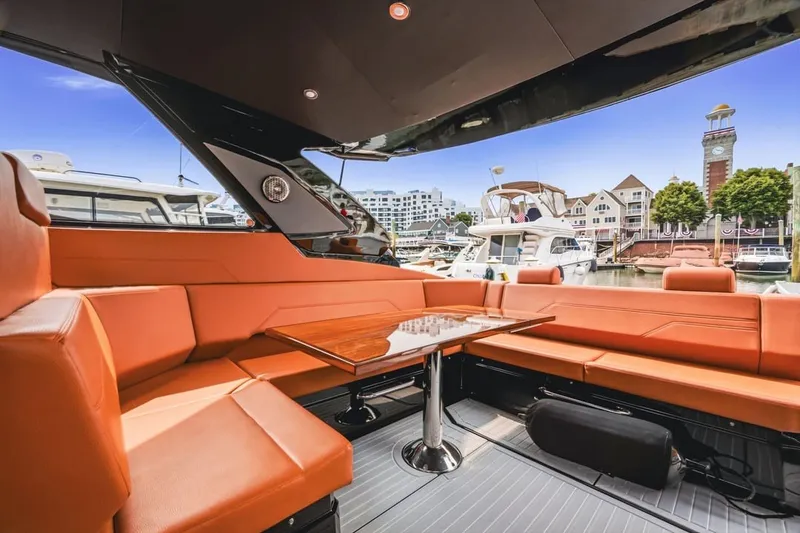 Slide: The Image of Luxurious 2022 Cruisers Yachts 42 GLS I/O with elegant orange seating in a marina setting. - 39