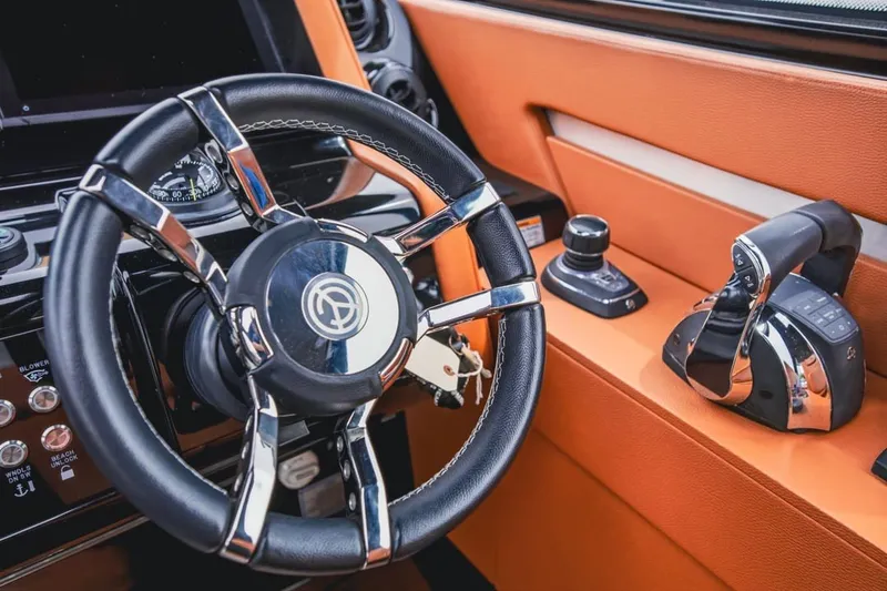 Slide: The Image of 2022 Cruisers Yachts 42 GLS I/O helm with sleek steering wheel and controls. - 74