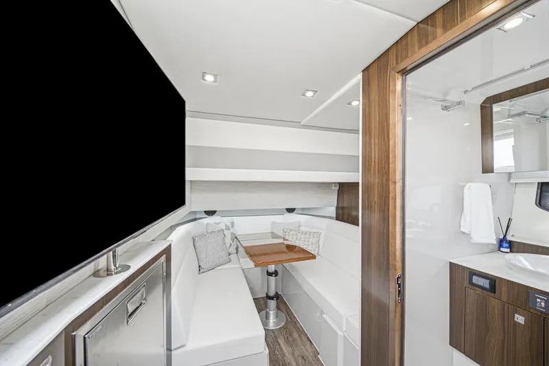 Slide: The Image of Luxurious interior of 2022 Cruisers Yachts 42 GLS I/O with modern seating and amenities. - 31