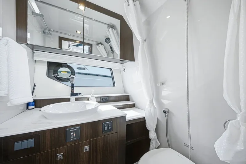 Slide: The Image of Luxurious bathroom in 2022 Cruisers Yachts 42 GLS I/O with modern fixtures and elegant design. - 22
