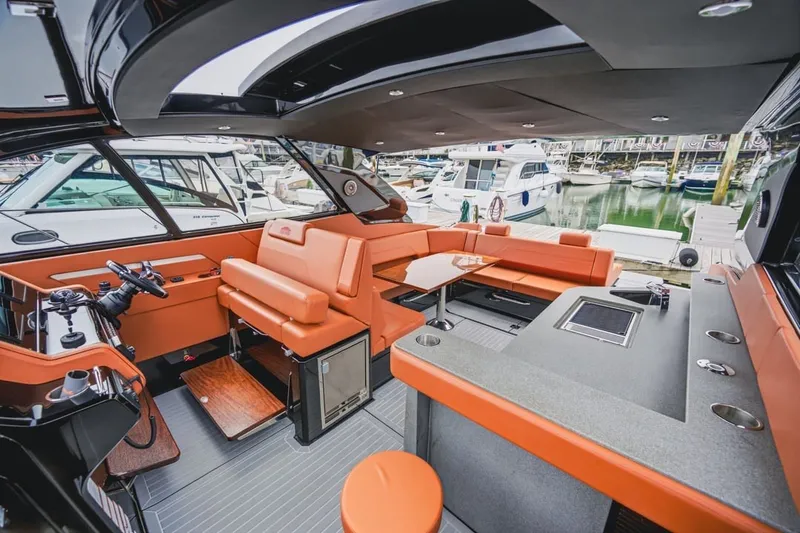 Slide: The Image of Luxurious 2022 Cruisers Yachts 42 GLS I/O interior with orange seating and modern amenities. - 65