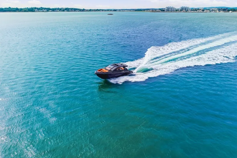 Slide: The Image of 2022 Cruisers Yachts 42 GLS I/O speeding on clear blue water. - 12