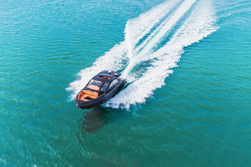 Slide: The Image of 2022 Cruisers Yachts 42 GLS I/O speeding on clear blue water. - 13