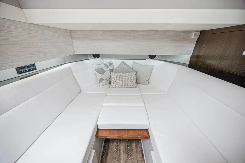 Slide: The Image of Luxurious interior of 2022 Cruisers Yachts 42 GLS I/O with white seating and cushions. - 67