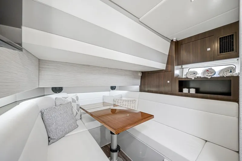 Slide: The Image of Luxurious interior of 2022 Cruisers Yachts 42 GLS I/O with elegant seating and wooden table. - 29