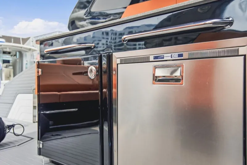 Slide: The Image of Outdoor kitchen area on 2022 Cruisers Yachts 42 GLS I/O with stainless steel appliances. - 50
