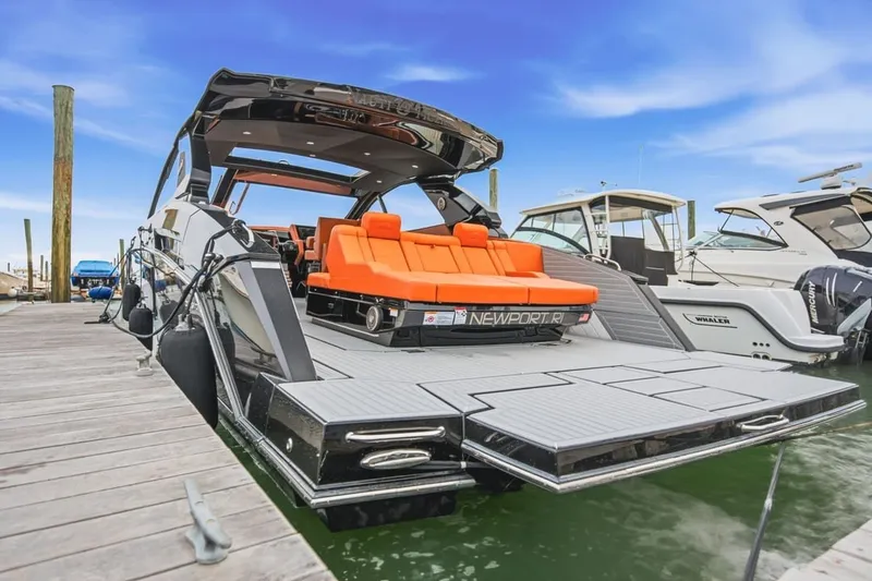 Slide: The Image of 2022 Cruisers Yachts 42 GLS I/O docked, featuring sleek design and vibrant orange seating. - 58