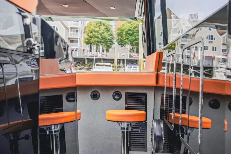 Slide: The Image of 2022 Cruisers Yachts 42 GLS I/O interior with orange seating and modern design. - 52