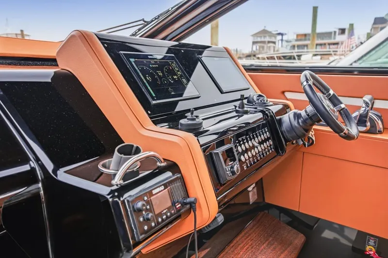 Slide: The Image of Helm of 2022 Cruisers Yachts 42 GLS I/O with modern controls and navigation display. - 44
