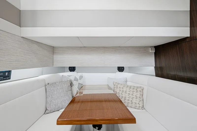 Slide: The Image of Interior of 2022 Cruisers Yachts 42 GLS I/O with elegant seating and wooden table. - 23