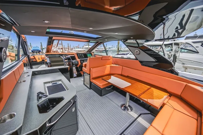 Slide: The Image of Luxurious interior of 2022 Cruisers Yachts 42 GLS I/O with orange seating and modern amenities. - 54