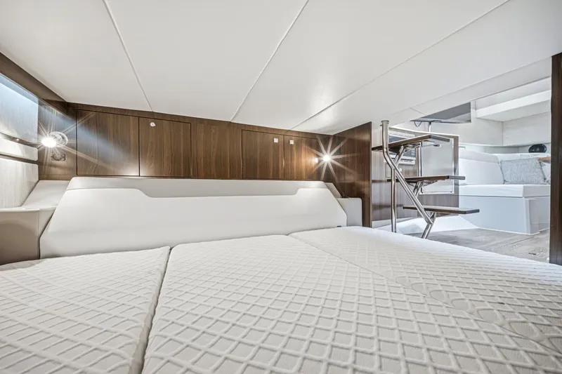 Slide: The Image of Luxurious interior of 2022 Cruisers Yachts 42 GLS I/O with modern design and comfortable bedding. - 27