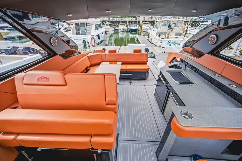 Slide: The Image of Luxurious 2022 Cruisers Yachts 42 GLS I/O interior with orange seating and modern amenities. - 66