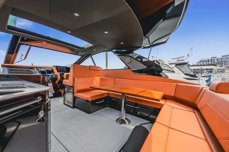 Slide: The Image of Luxurious interior of 2022 Cruisers Yachts 42 GLS I/O with orange seating and modern design. - 40