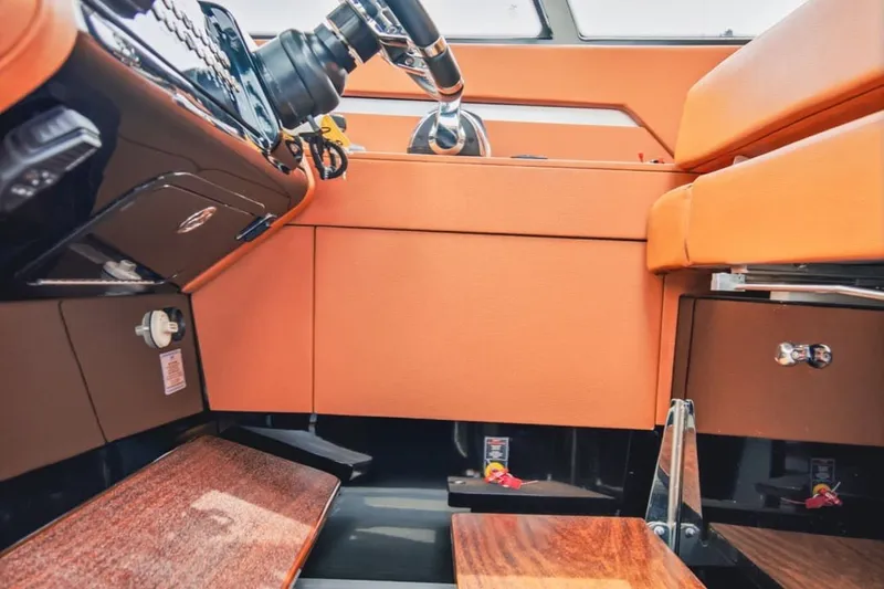 Slide: The Image of Interior of 2022 Cruisers Yachts 42 GLS I/O with orange seating and modern controls. - 76