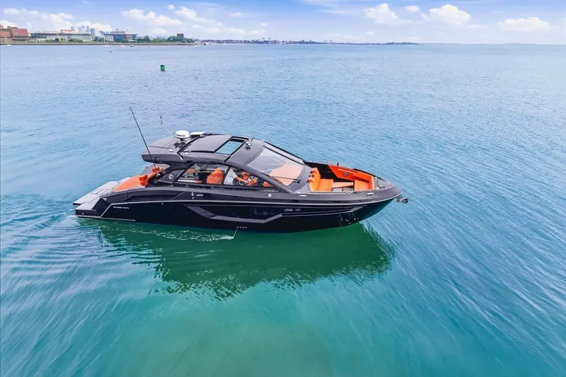 Slide: The Image of 2022 Cruisers Yachts 42 GLS I/O on calm blue water, showcasing sleek design. - 6