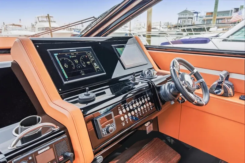 Slide: The Image of 2022 Cruisers Yachts 42 GLS I/O helm with modern controls and navigation displays. - 42